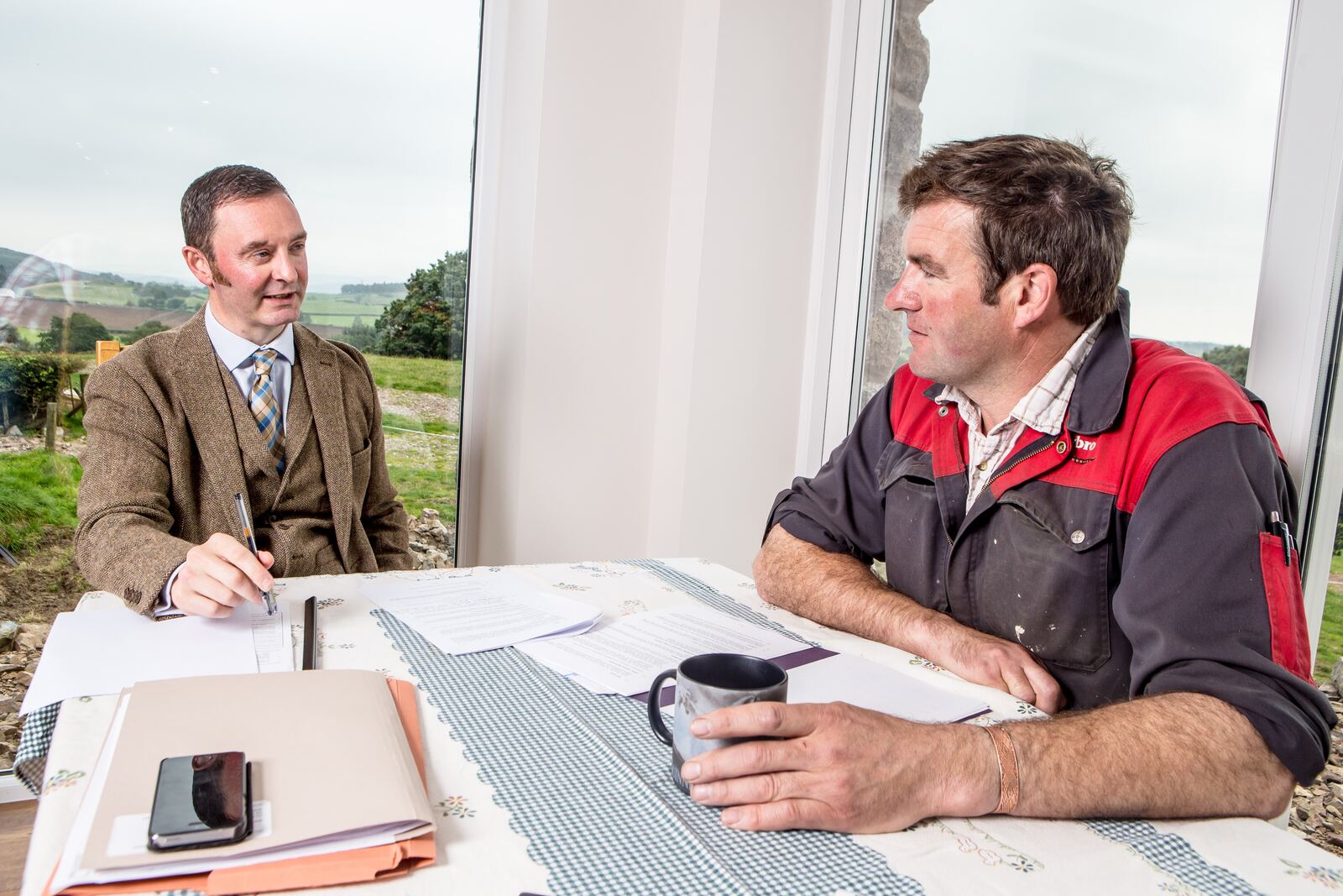 David Hall meeting a farmer at a farmhouse kitchen table