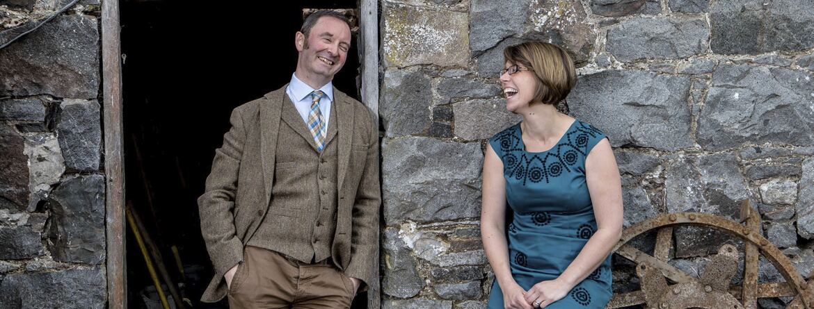 David Hall and Karen Baird at the door of a stone barn